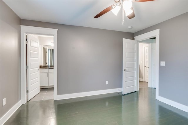 unfurnished bedroom featuring hardwood / wood-style floors, ensuite bathroom, and ceiling fan