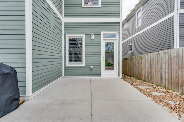 view of exterior entry featuring a patio area