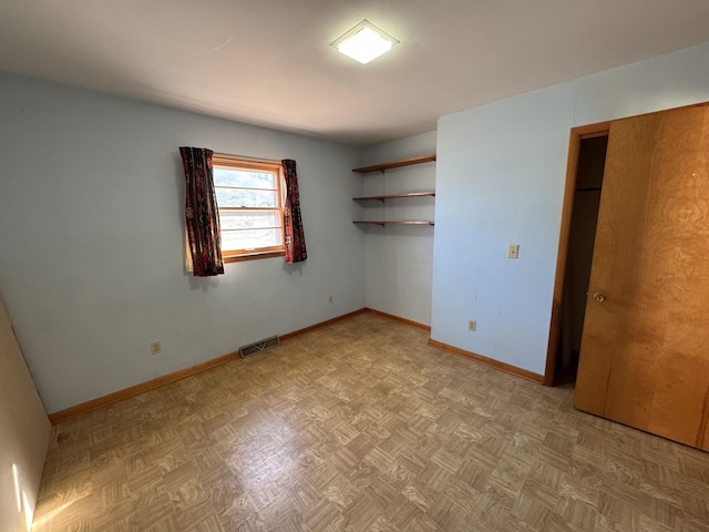 unfurnished bedroom featuring light parquet flooring