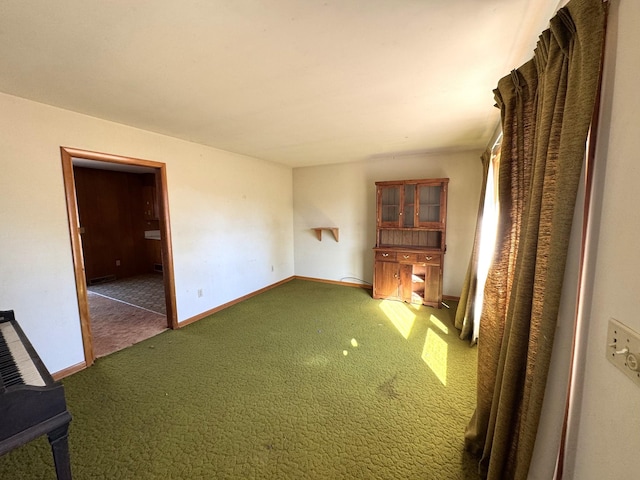 unfurnished living room featuring dark colored carpet