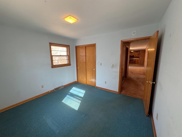 unfurnished bedroom featuring a closet and carpet