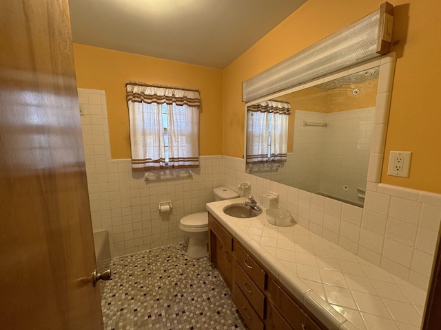 bathroom featuring tile patterned floors, vanity, tile walls, toilet, and tiled shower