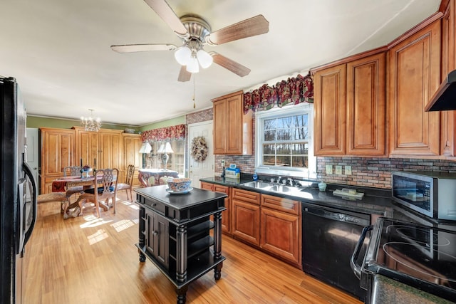 kitchen featuring black appliances, sink, backsplash, light wood-type flooring, and ceiling fan