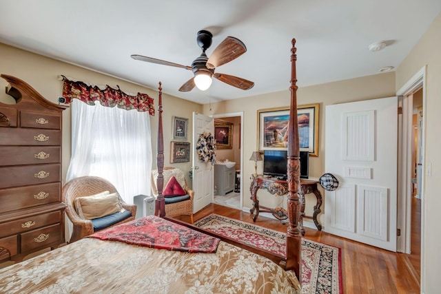 bedroom with ceiling fan, light hardwood / wood-style floors, and connected bathroom