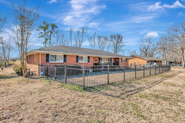 rear view of property with a covered pool, a patio area, and a lawn