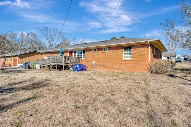 rear view of house featuring a deck