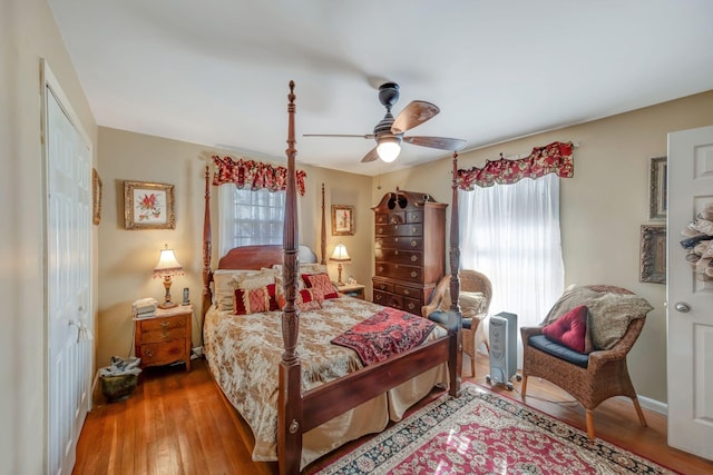 bedroom featuring ceiling fan, hardwood / wood-style floors, and a closet