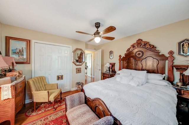 bedroom featuring ceiling fan, hardwood / wood-style flooring, and a closet