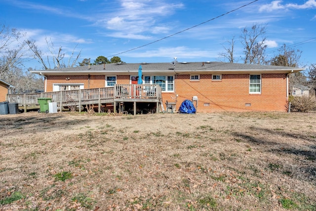 back of house with a wooden deck and a yard