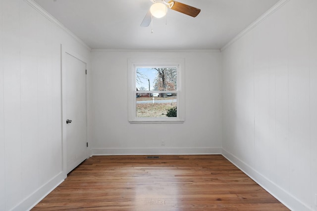 empty room with crown molding, ceiling fan, and hardwood / wood-style floors