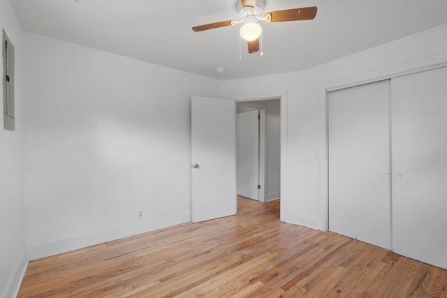 unfurnished bedroom with ceiling fan, a closet, and light wood-type flooring