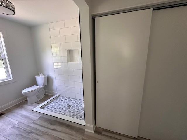 bathroom with toilet and walk in shower