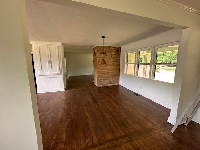 unfurnished living room with dark wood-type flooring