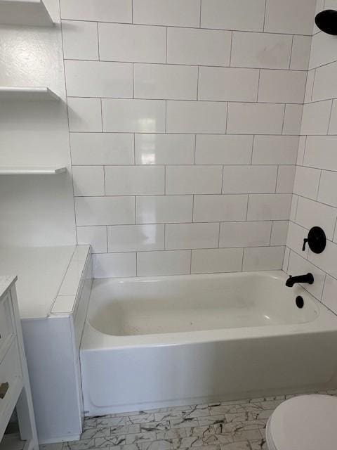 full bathroom with toilet, vanity, and tiled shower / bath combo