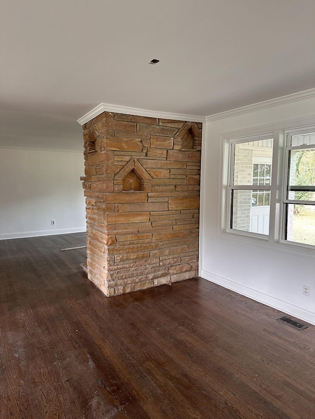 empty room featuring dark hardwood / wood-style flooring and ornamental molding