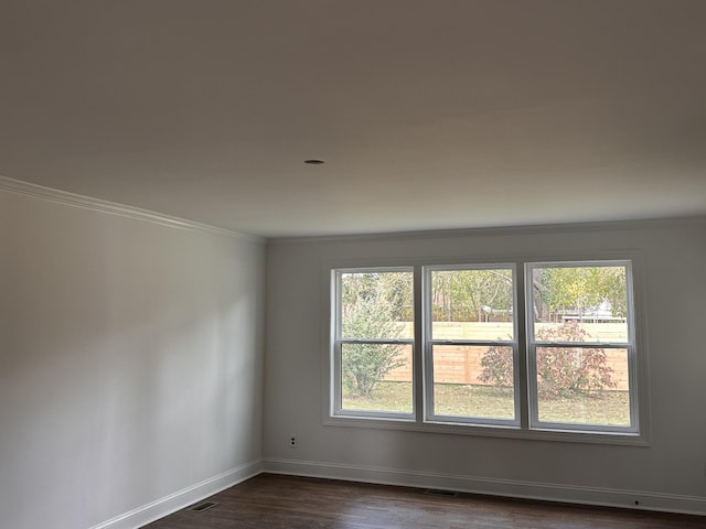 spare room with dark hardwood / wood-style floors and ornamental molding