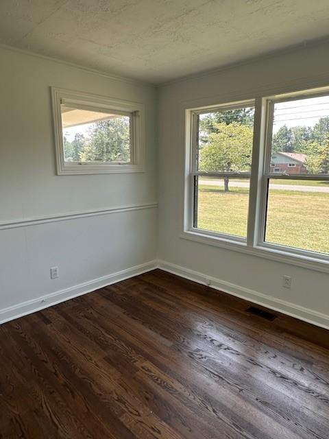 empty room with dark hardwood / wood-style flooring