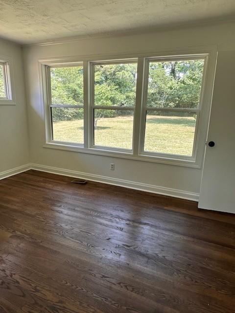 empty room with dark hardwood / wood-style floors