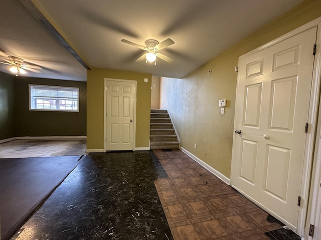 interior space with ceiling fan