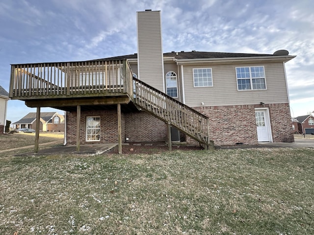 back of property with a wooden deck, a yard, and a patio