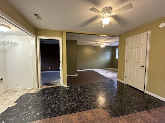 unfurnished room with ceiling fan