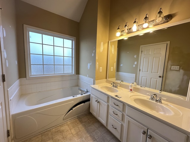 bathroom featuring vanity and a tub