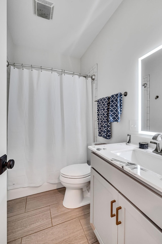 full bathroom featuring vanity, toilet, and shower / bathtub combination with curtain