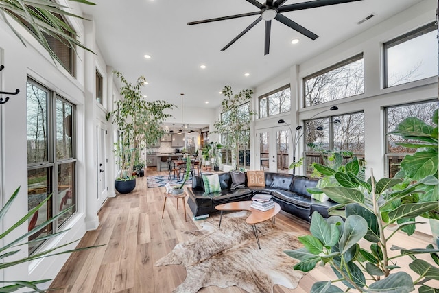 sunroom featuring ceiling fan and french doors