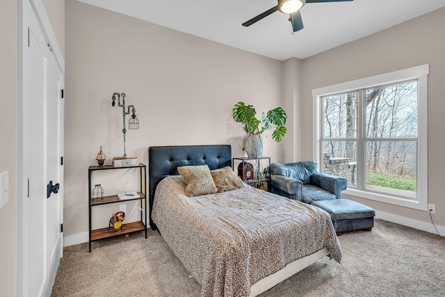 carpeted bedroom featuring a closet and ceiling fan