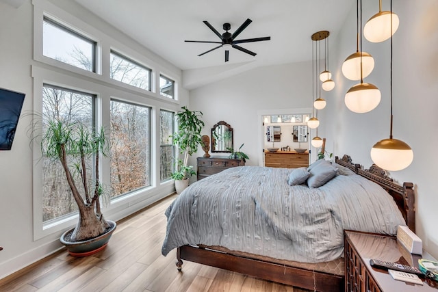 bedroom with light wood-type flooring and vaulted ceiling