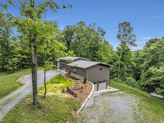 view of front of house with a garage, covered porch, and a front yard