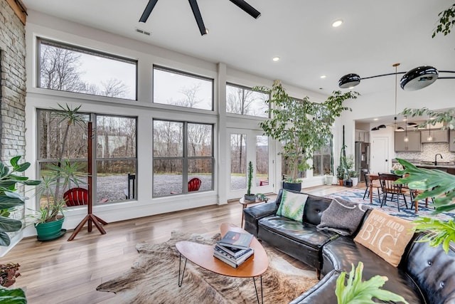 sunroom / solarium with sink and ceiling fan