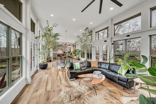 sunroom / solarium featuring ceiling fan and french doors