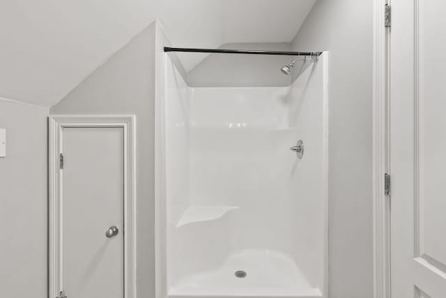 bathroom with a shower and vaulted ceiling