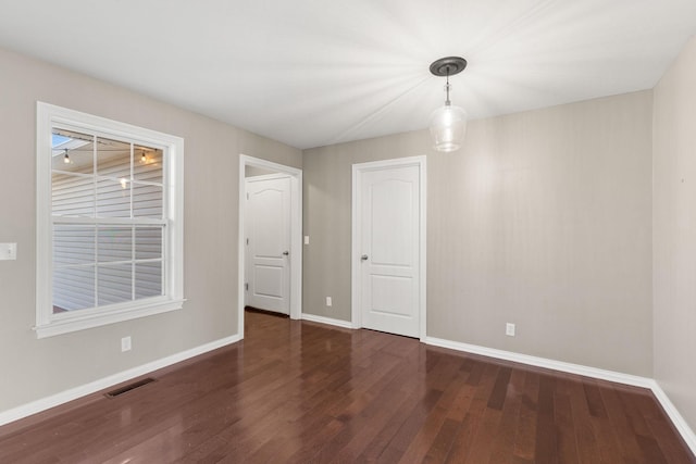 unfurnished room featuring dark hardwood / wood-style flooring