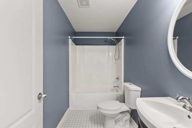 full bathroom featuring sink, toilet,  shower combination, and tile patterned flooring