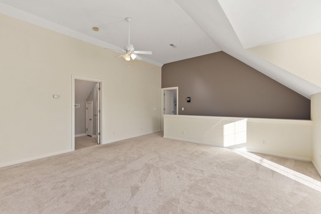 interior space featuring vaulted ceiling, ceiling fan, and light carpet