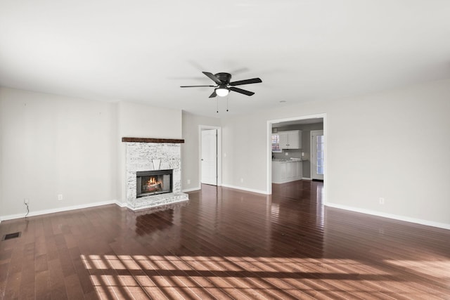 unfurnished living room with ceiling fan and dark hardwood / wood-style flooring