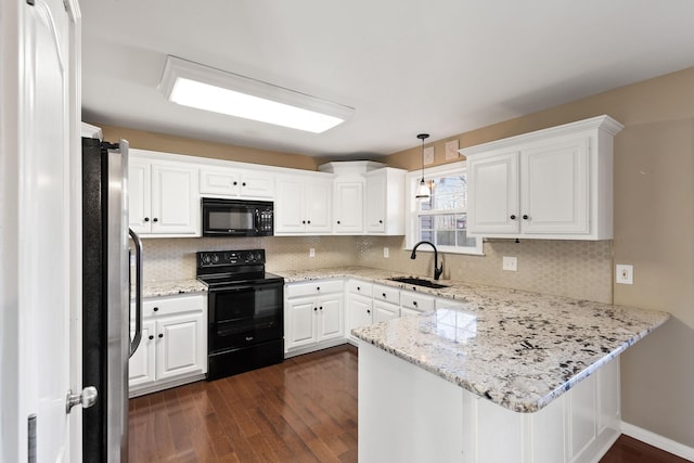 kitchen with black appliances, hanging light fixtures, white cabinets, sink, and kitchen peninsula