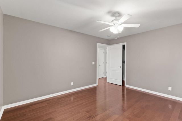 unfurnished room featuring ceiling fan and dark hardwood / wood-style flooring