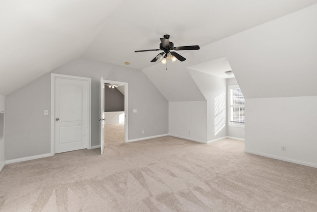 bonus room featuring ceiling fan, light carpet, and vaulted ceiling