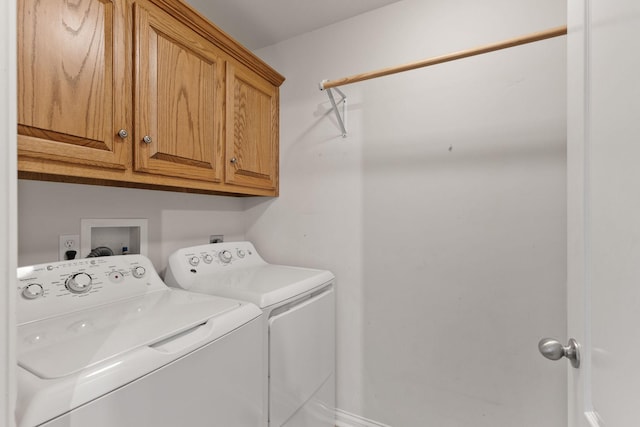 laundry area featuring cabinets and washing machine and dryer