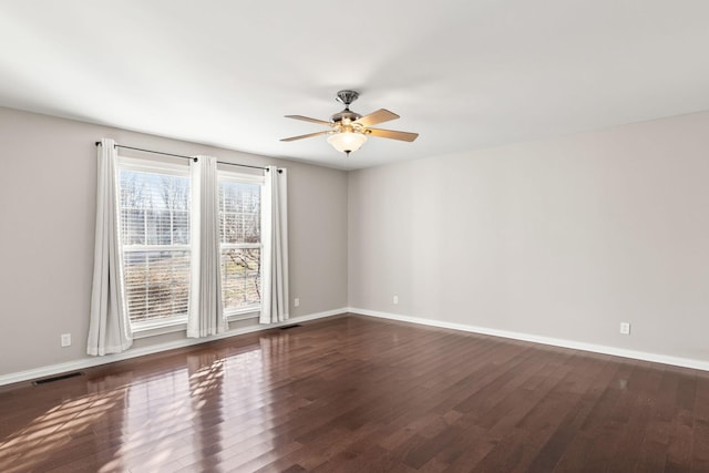 spare room featuring ceiling fan and dark hardwood / wood-style floors