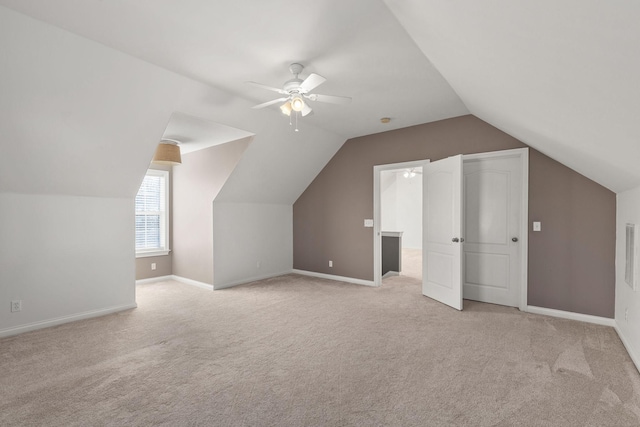 additional living space with ceiling fan, light carpet, and vaulted ceiling