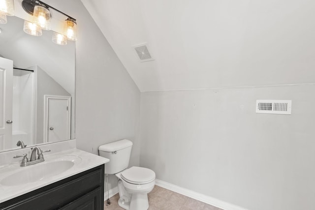 bathroom with a shower, toilet, vanity, and vaulted ceiling