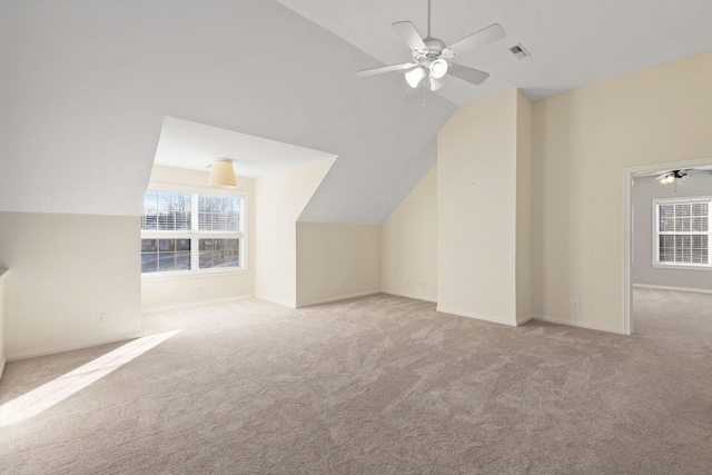 bonus room with vaulted ceiling, ceiling fan, and light carpet