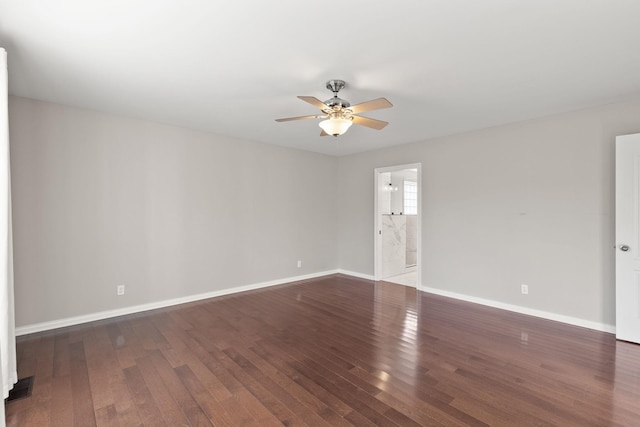 empty room featuring ceiling fan and dark hardwood / wood-style flooring