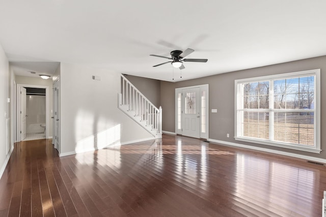 unfurnished living room featuring ceiling fan and dark hardwood / wood-style flooring