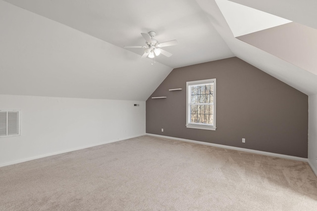 additional living space with ceiling fan, carpet floors, and lofted ceiling