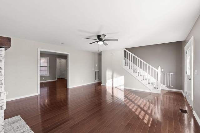 unfurnished living room featuring ceiling fan and dark hardwood / wood-style flooring